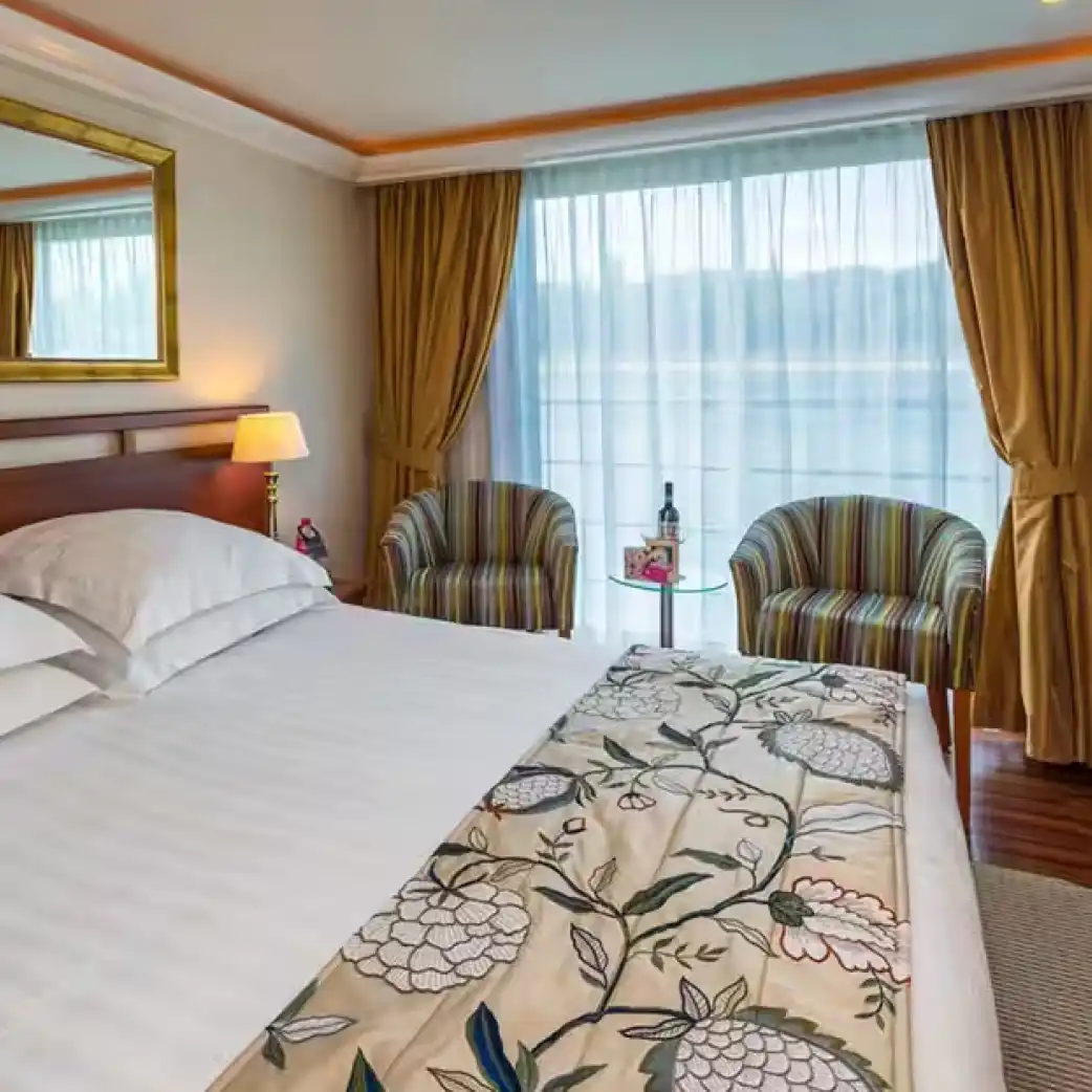 AmaDante French balcony cabin with seating beside floor-to-ceiling windows